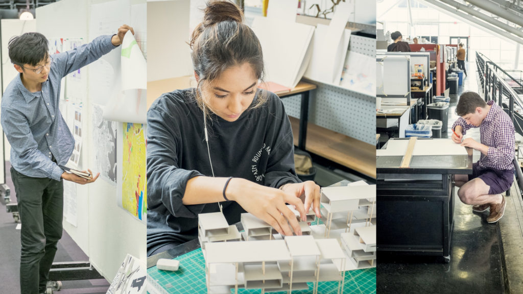 An image of three Design Discovery program participants inside Gund Hall at Harvard's Graduate School of Design. Two of the students are building models at their studio desks and one student is standing, presenting design work as he flips through a set of drawings that are pinned to a wall.