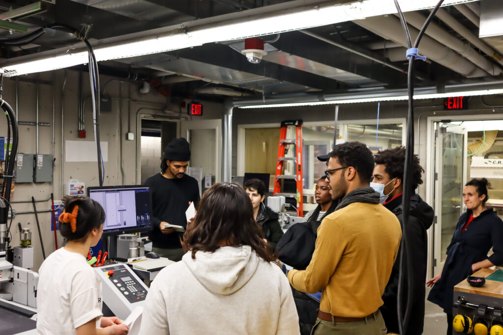 Another image of the program participants touring the Harvard Graduate School of Design's fabrication laboratory.  